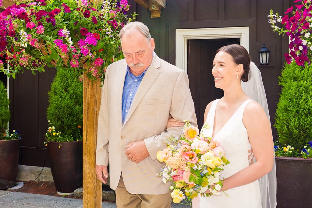 Bride and groom embracing during their Robinswood House wedding in Bellevue on a sunny summer day