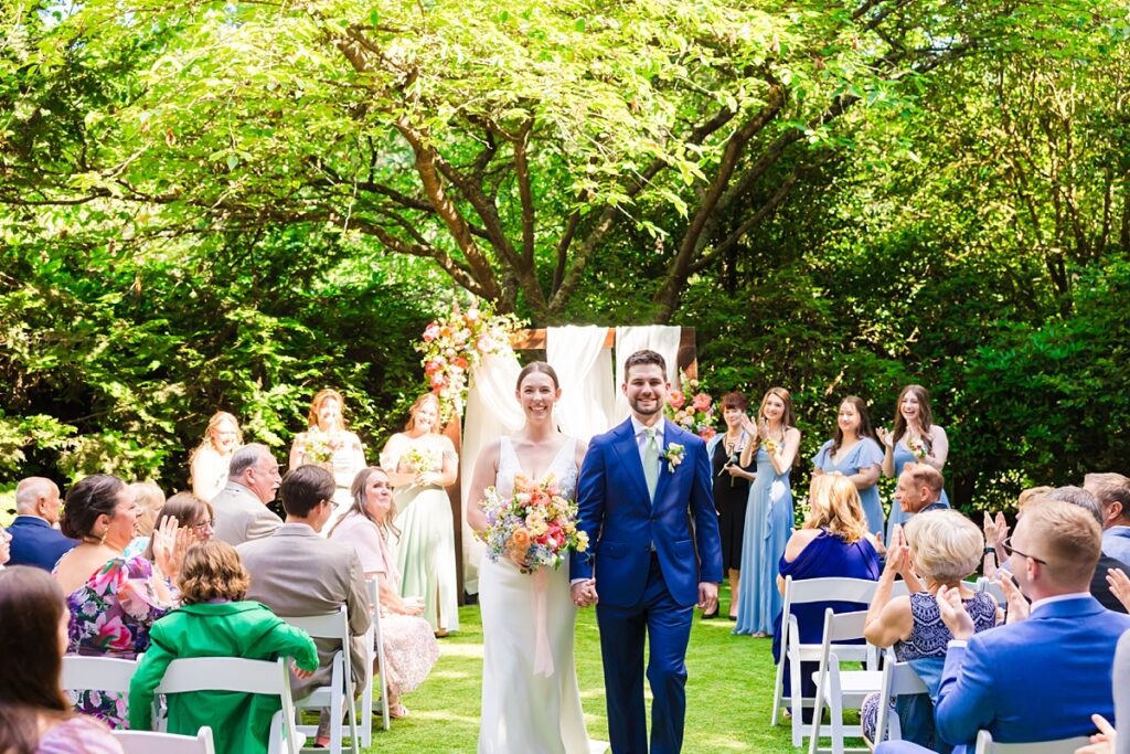 Bride and groom embracing during their Robinswood House wedding in Bellevue on a sunny summer day