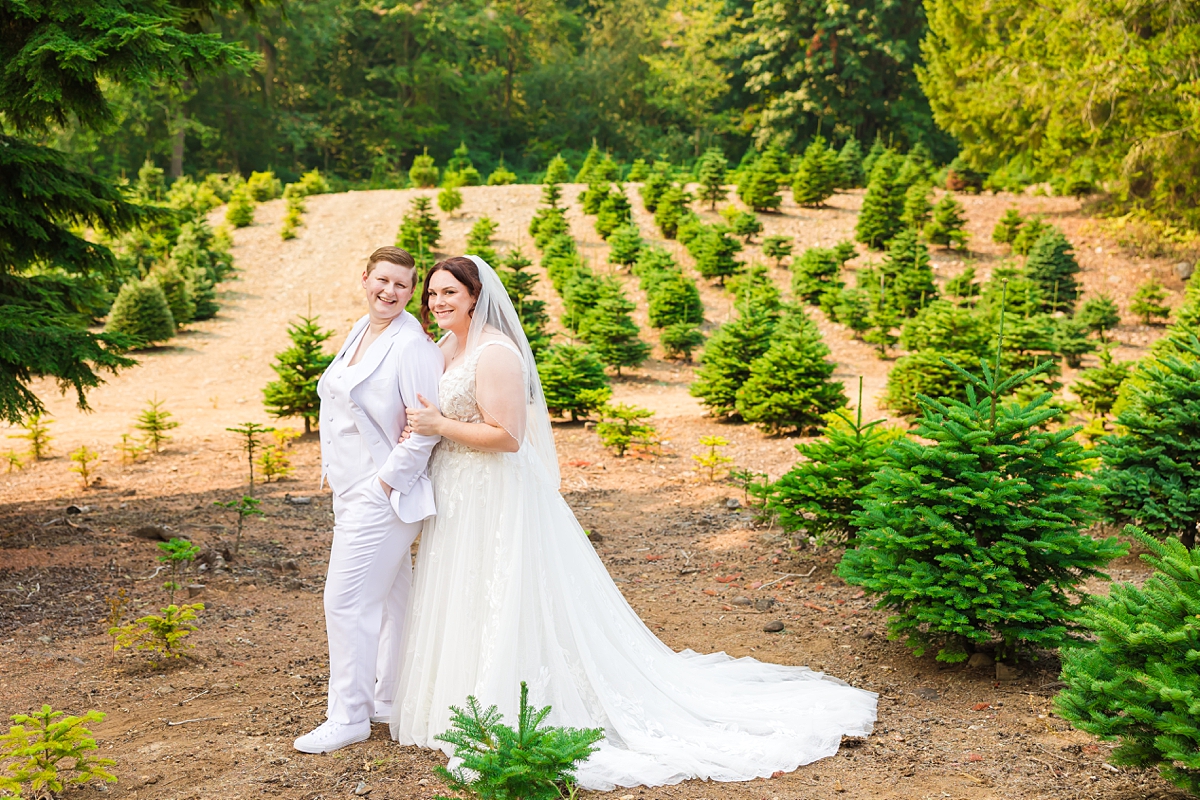 Jade and Sam smiling during their same-sex wedding at Trinity Tree Farm in Issaquah