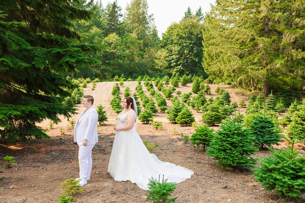 Jade and Sam smiling during their same-sex wedding at Trinity Tree Farm in Issaquah