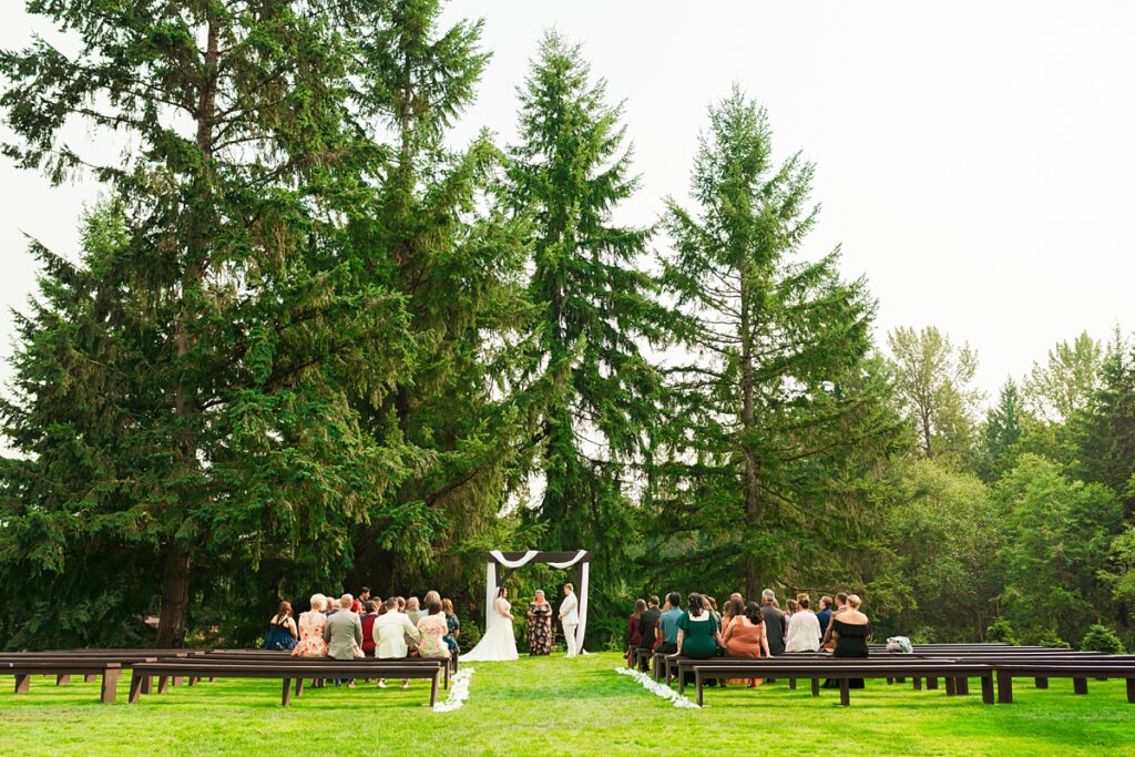 Jade and Sam smiling during their same-sex wedding at Trinity Tree Farm in Issaquah