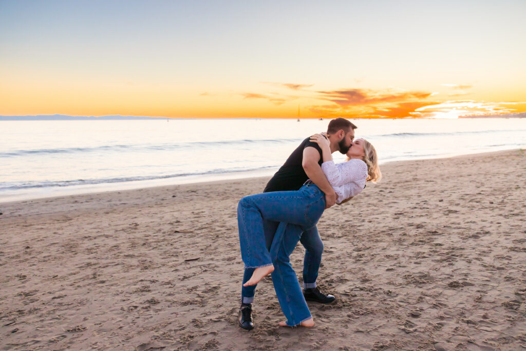 Victoria and Jonathan walking along Butterfly Beach during sunset engagement photos in Santa Barbara.
