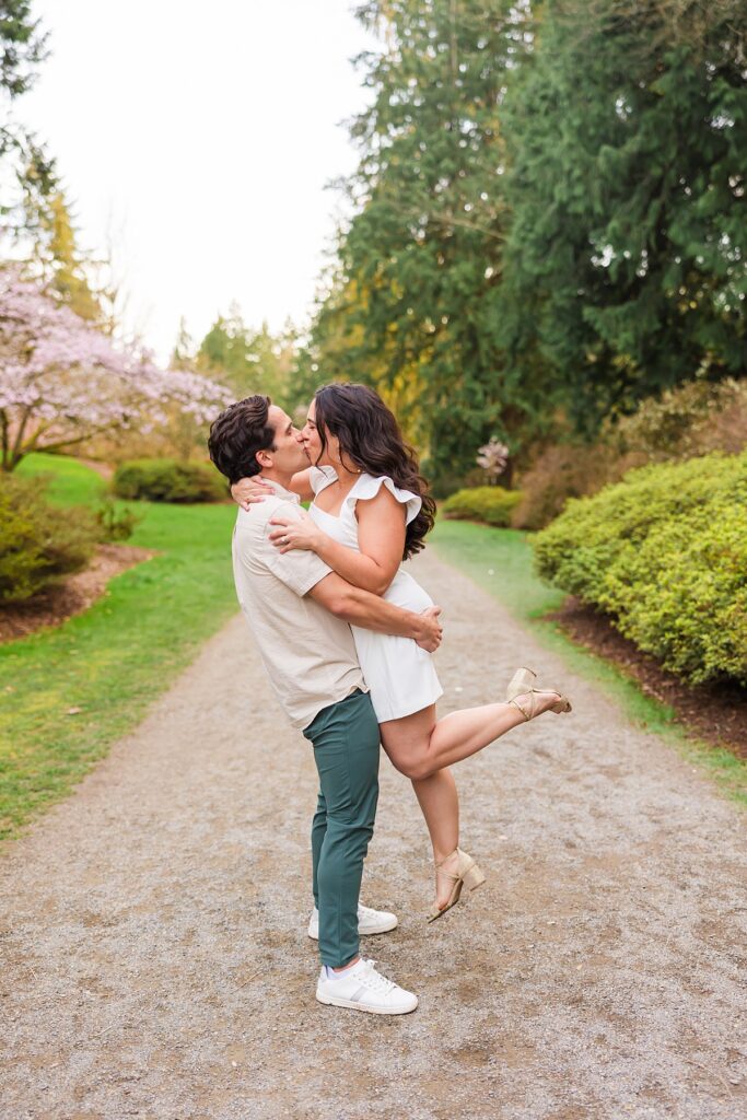 Seattle engagement photos at Washington Park Arboretum with cherry blossoms and couple embracing