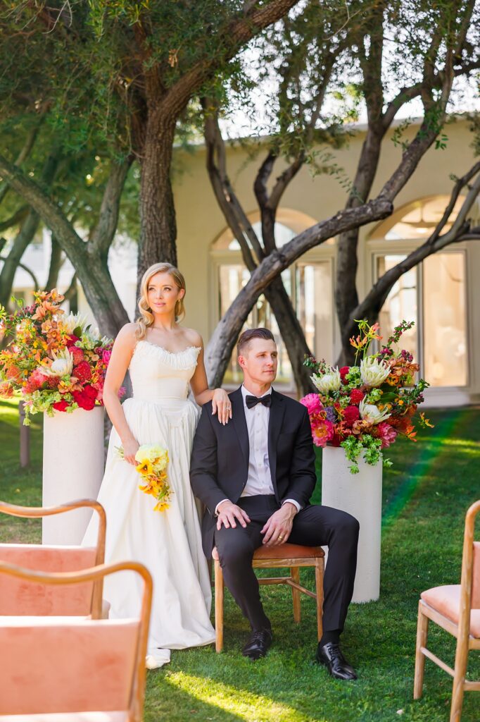 Bride and groom standing at their colorful outdoor wedding ceremony at Casa Palma in Palm Springs