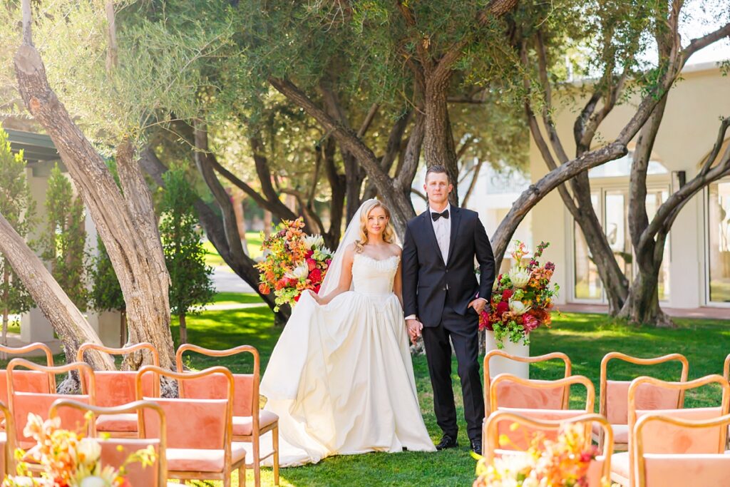 Bride and groom standing at their colorful outdoor wedding ceremony at Casa Palma in Palm Springs