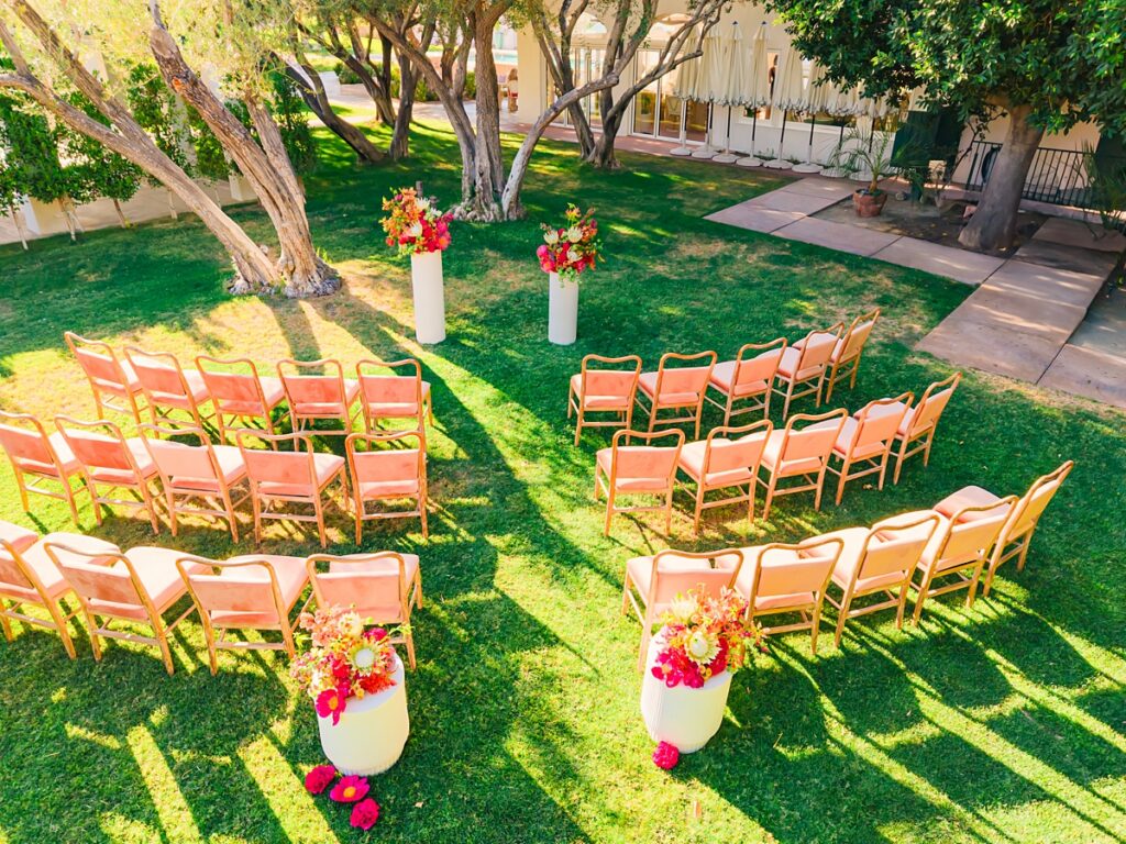 Outdoor wedding ceremony setup at Casa Palma in Palm Springs with colorful florals and garden view