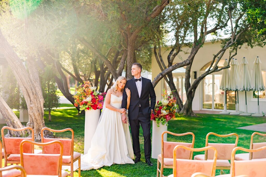Bride and groom standing at their colorful outdoor wedding ceremony at Casa Palma in Palm Springs