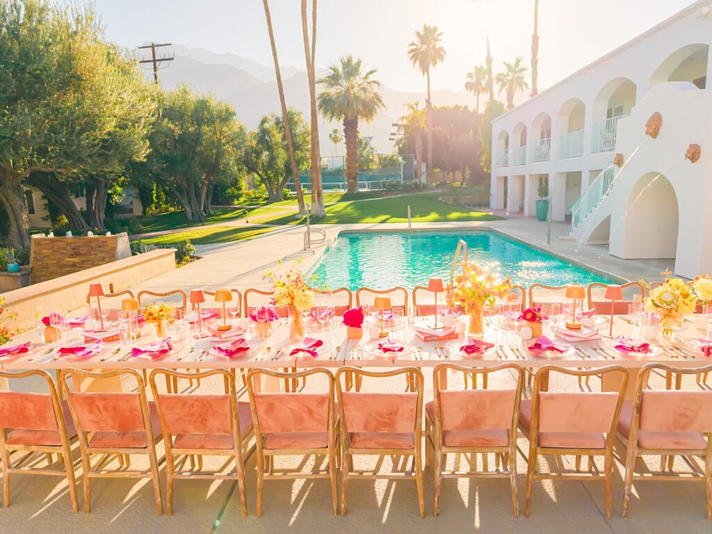 Colorful poolside reception table design at Casa Palma in Palm Springs with vibrant florals and pink details