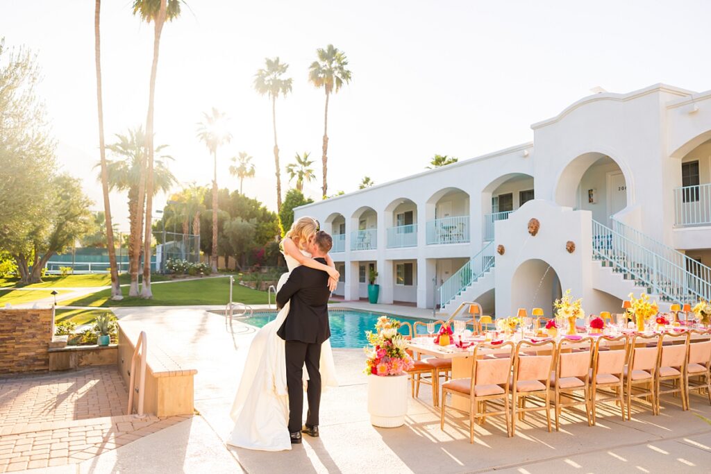 Bride and groom dancing beside a colorful poolside reception at Casa Palma in Palm Springs