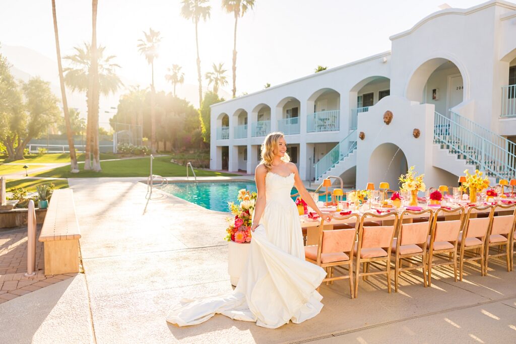Bride and groom dancing beside a colorful poolside reception at Casa Palma in Palm Springs
