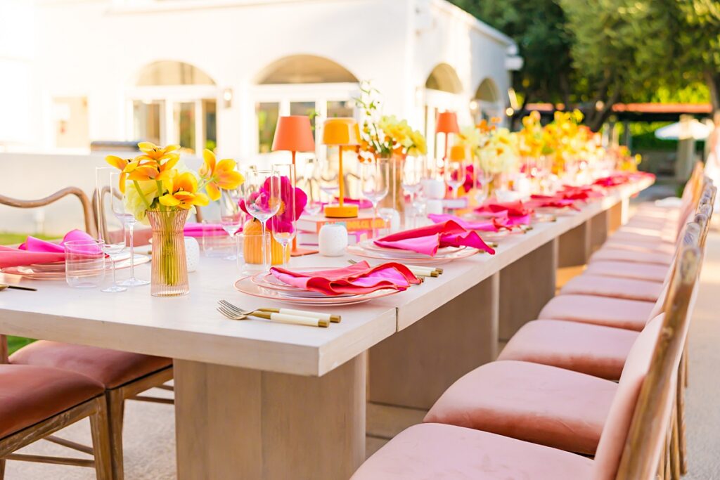 Colorful poolside reception table design at Casa Palma in Palm Springs with vibrant florals and pink details