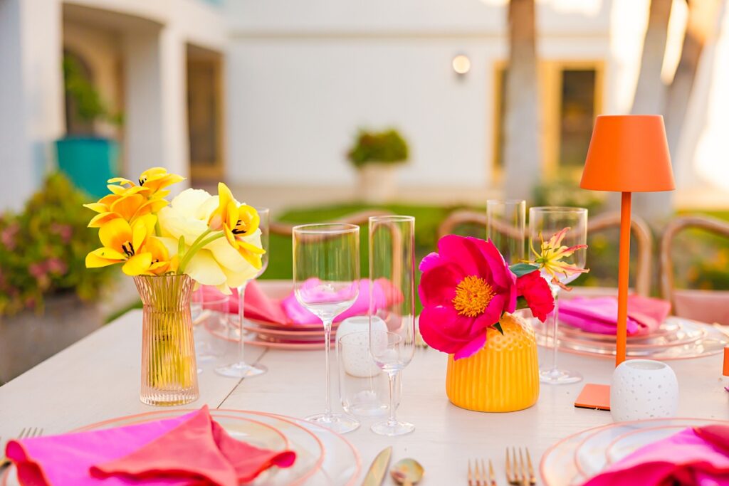 Colorful poolside reception table design at Casa Palma in Palm Springs with vibrant florals and pink details