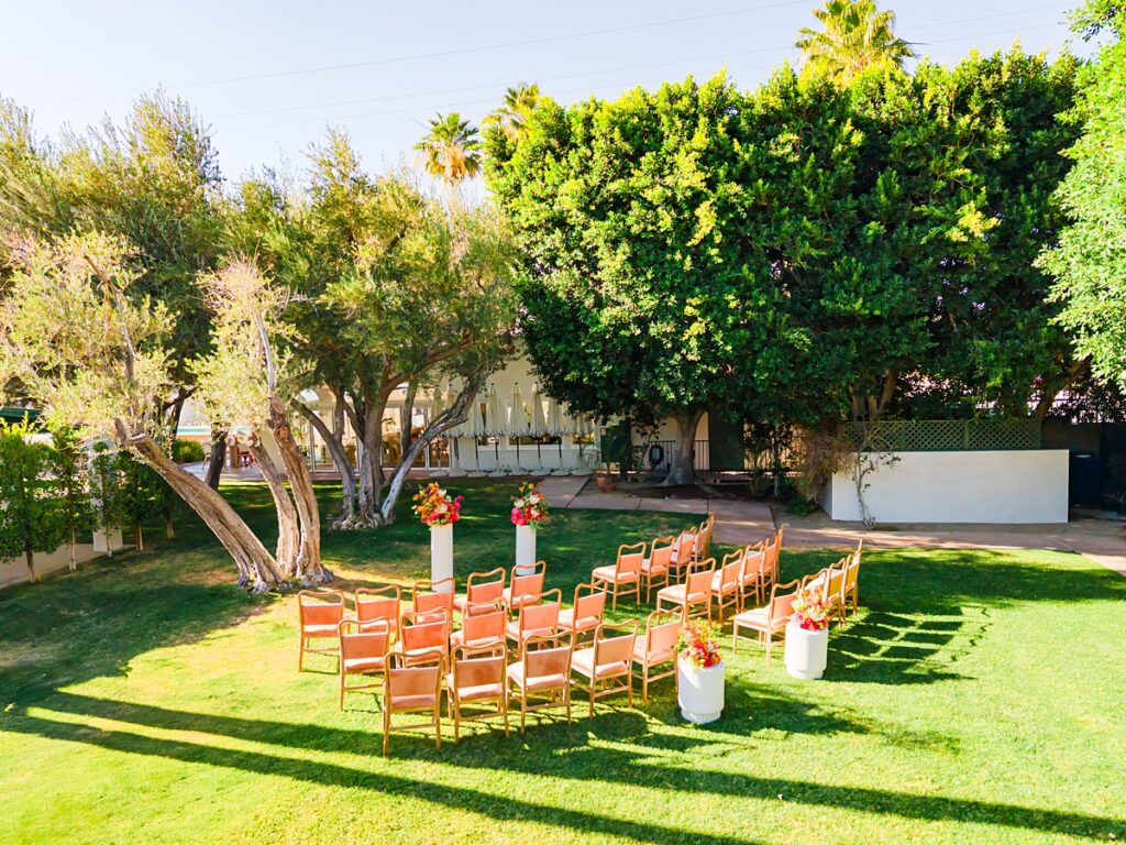 Outdoor wedding ceremony setup at Casa Palma in Palm Springs with colorful florals and garden view